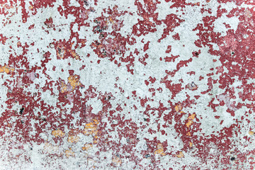 abstract texture of cracked red paint on wall