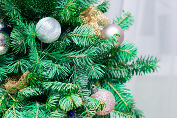 New Year coniferous tree decorated with Christmas ornament, balls,