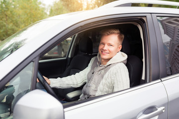 Attractive elegant happy man in good expencive car