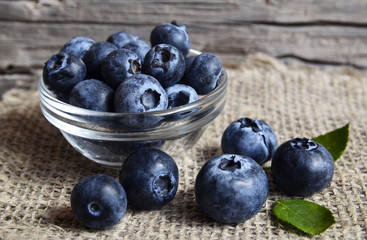 Fresh organic blueberries in a glass bowl on old wooden background.Blueberry.
Bilberries.Healthy eating,vegan food,diet and nutrition concept.Selective focus.