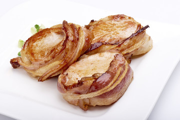 Pork fillet wrapped in bacon, isolated on white background