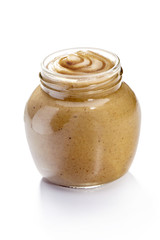 Glass jar of mustard, isolated on white background