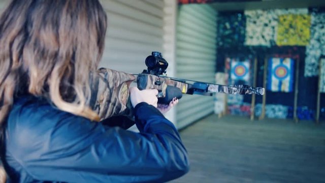 Pretty girl shoots a crossbow