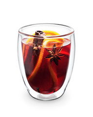 Double wall glass cup with mulled wine spices, orange, anise and cinnamon sticks isolated on white background.