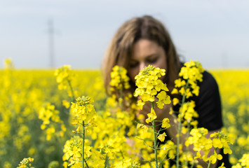 Girl in yellow rapeseed field
