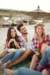 Group of cheerful friends having great time at beach