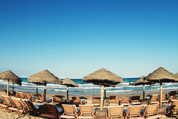 beach umbrellas and sun loungers on the sand near the sea
