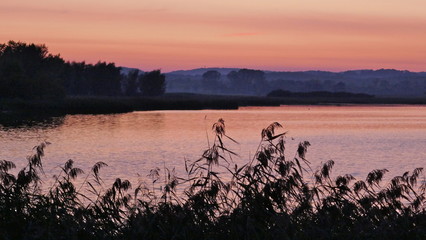 Naklejka premium Dramatic sunset at a lake in Schleswig-Holstein, Germany