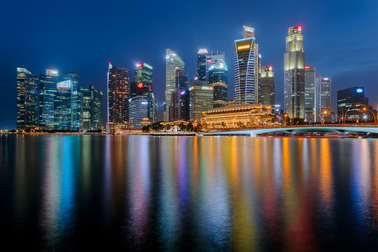 Singapore city downtown reflecting in water at Marina Bay