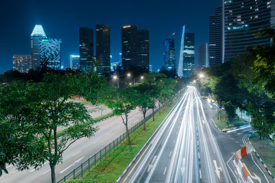 Singapore city skyline. Light trails on the road