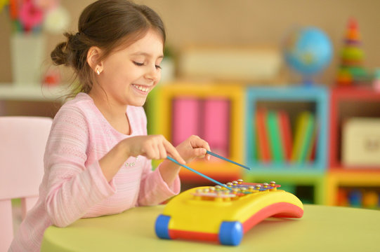 girl playing with musical toy