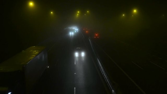 A traffic at fogy evening  in winter in Prague.Night City Traffic In The Fog