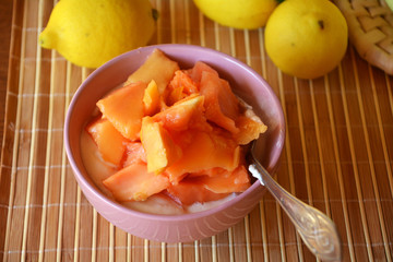 Healthy breakfast ripe chopped papaya with cottage cheese on a bowl.