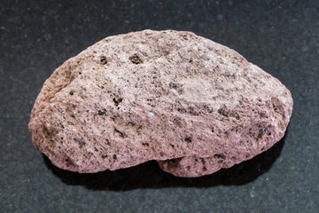 red pumice pebble on dark background