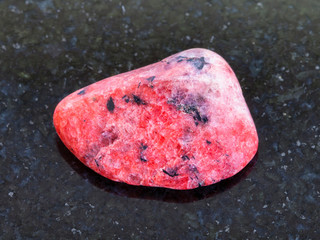 polished red Agate gemstone on dark background