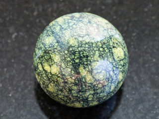 ball from Serpentine gemstone on dark