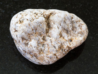 pebble of white Granite stone on dark background