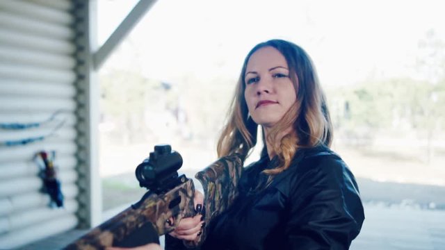 Pretty girl shoots a crossbow