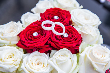 weiße Bergkristall Ringe, Trauringe auf Rosenstrauß, rote Rosen, weiße Rosen, Glitzersteine