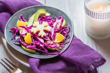 Red Cabbage salad with orange and avocado, cheese in the form of snowflakes Healthy food, clean eating or diet concept. Vegetarian dish.