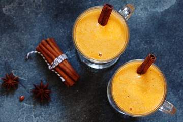 Pumpkin spice latte, hot coffee drink with pumpkin and cinnamon top view