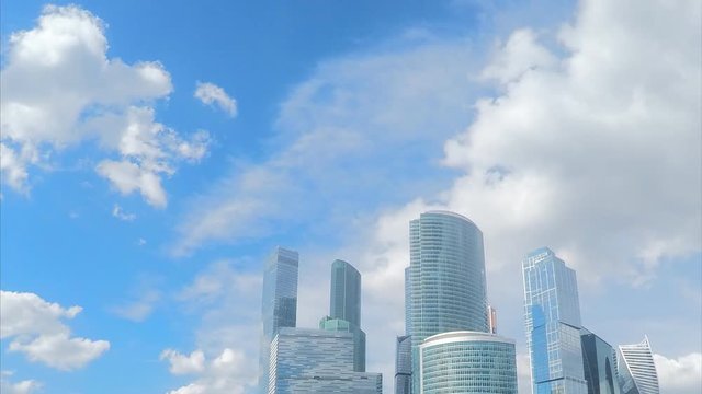 different glass towers and sky with clouds timelapse