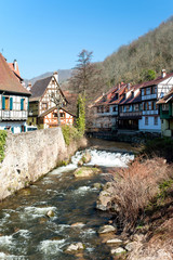 Fototapeta na wymiar French traditional half-timbered houses and La Weiss river in Kayserberg