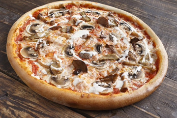 Big pizza on a wooden surface. Selective focus