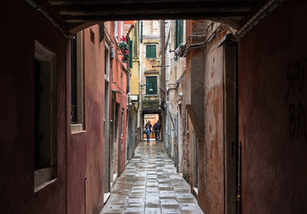 Fototapeta na wymiar People in the end of a narrow venetian street, Venice