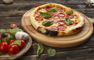 Big pizza on a wooden surface. Selective focus