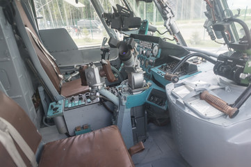 Control panel in military helicopter cockpit, copter dashboard with displays, dials, buttons, switches, faders, knobs, other toggle items, air force, modern aviation and aerospace industry