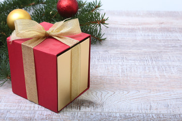 Fototapeta na wymiar Christmas fir tree with gift box on wooden board