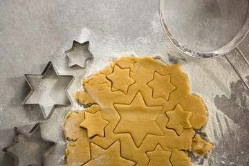 Raw cookie dough with star shape and cutter