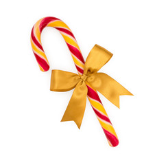 Christmas candy cane with gold bow isolated on white background, top view.