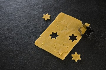 Raw cookie dough with star shaped cookie cutter