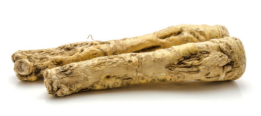 Pair of fresh horseradish root isolated on white background