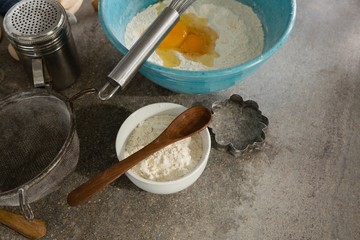 Gingerbread cookies ingredients with various utensils on table