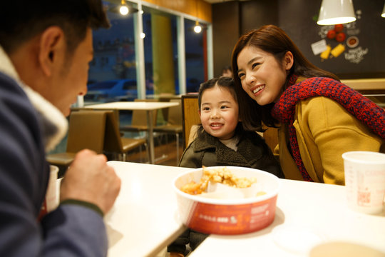 Happy family dining in a restaurant