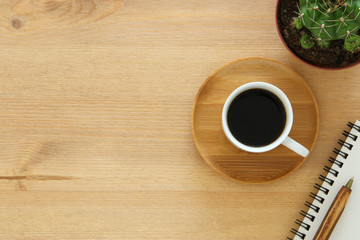 top view image of cup of coffee on wooden table.