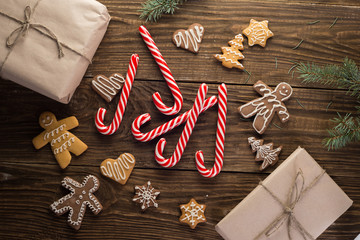 Chrismas cookies, candy canes on wooden background. Holiday mood. Top view.