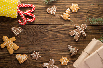 Obraz na płótnie Canvas Chrismas cookies, candy canes on wooden background. Holiday mood. Top view.