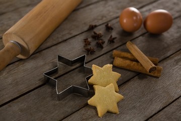 Rolling pin with eggs, cookie cutter, cookies, cinnamon and
