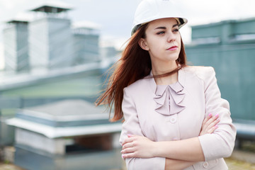 Pretty businesswoman in beige suit stand on the roof