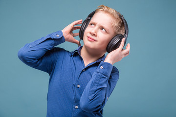 Teenage boy in blue shirt and headphones