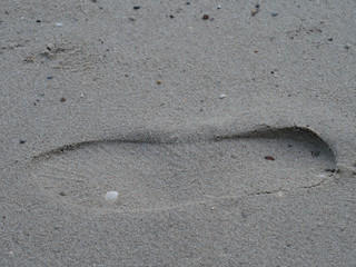 shoe print on sand at the beach