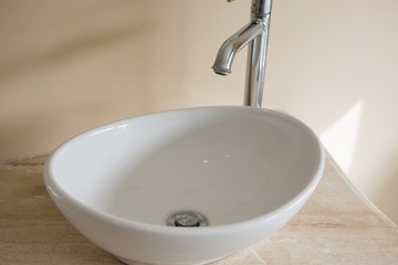 Close-up of faucet and sink in bathroom