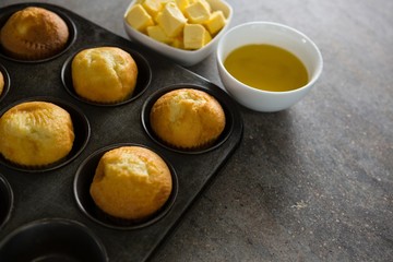 Cupcakes and cheese arranged on a concrete background