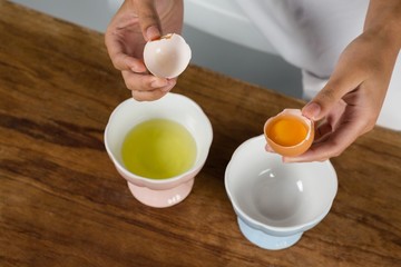 Woman holding a broken egg