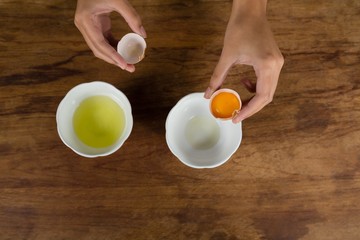 Woman holding a broken egg