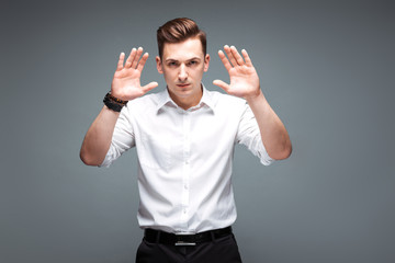 Fototapeta premium Young handsome businessman in costly watch and white shirt